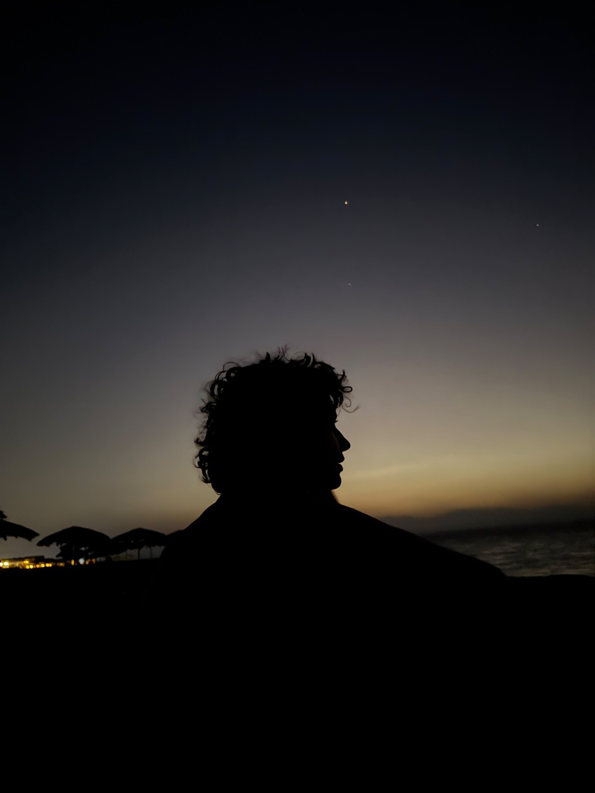 Maha at dusk, in silhouette against the sea